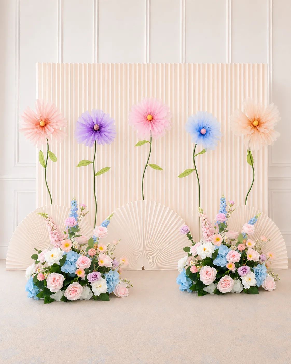 Pastel organza flower backdrop with pleated wall and floral hedges