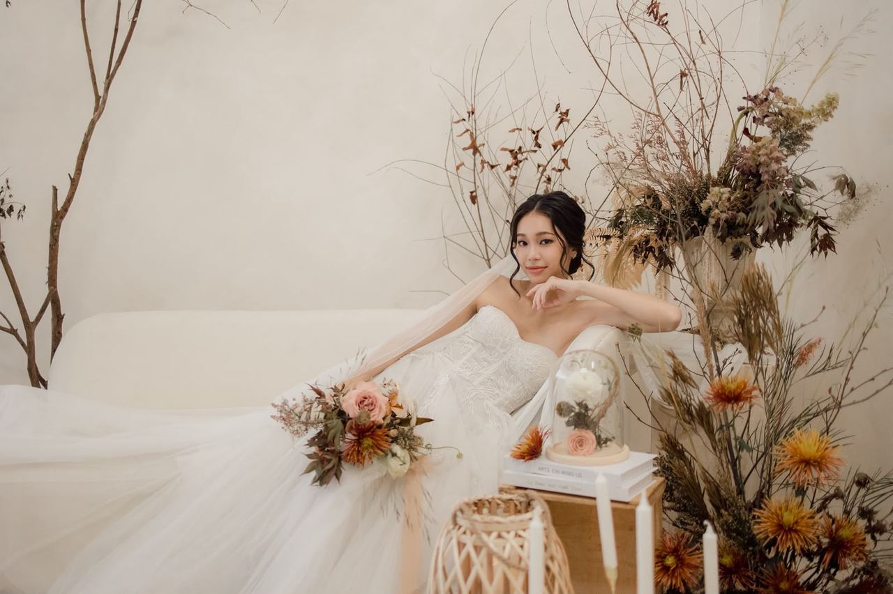 Bride in a white wedding gown showcasing Beauty Buzz bridal makeup and hairstyling