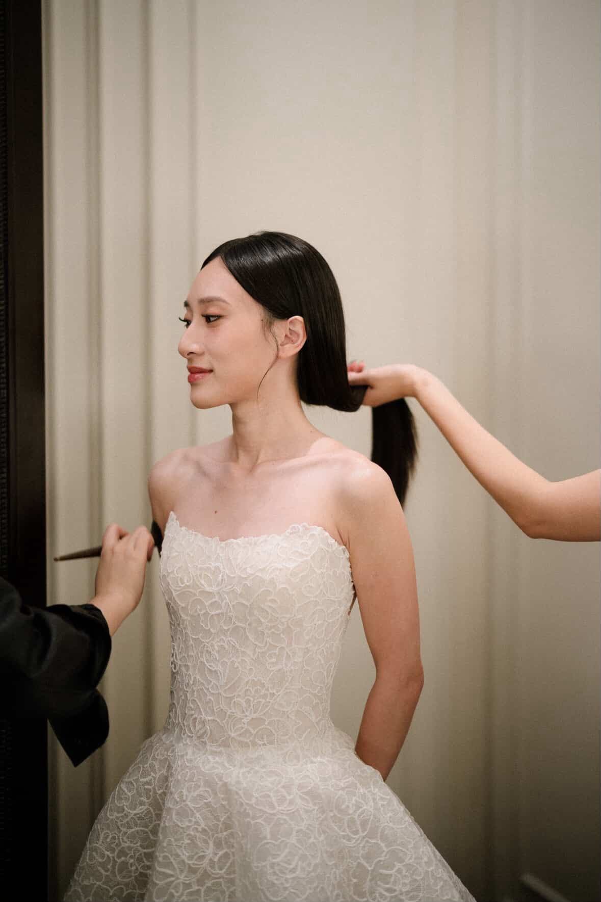 Bride receiving wedding makeup by The Rorrimu Bride