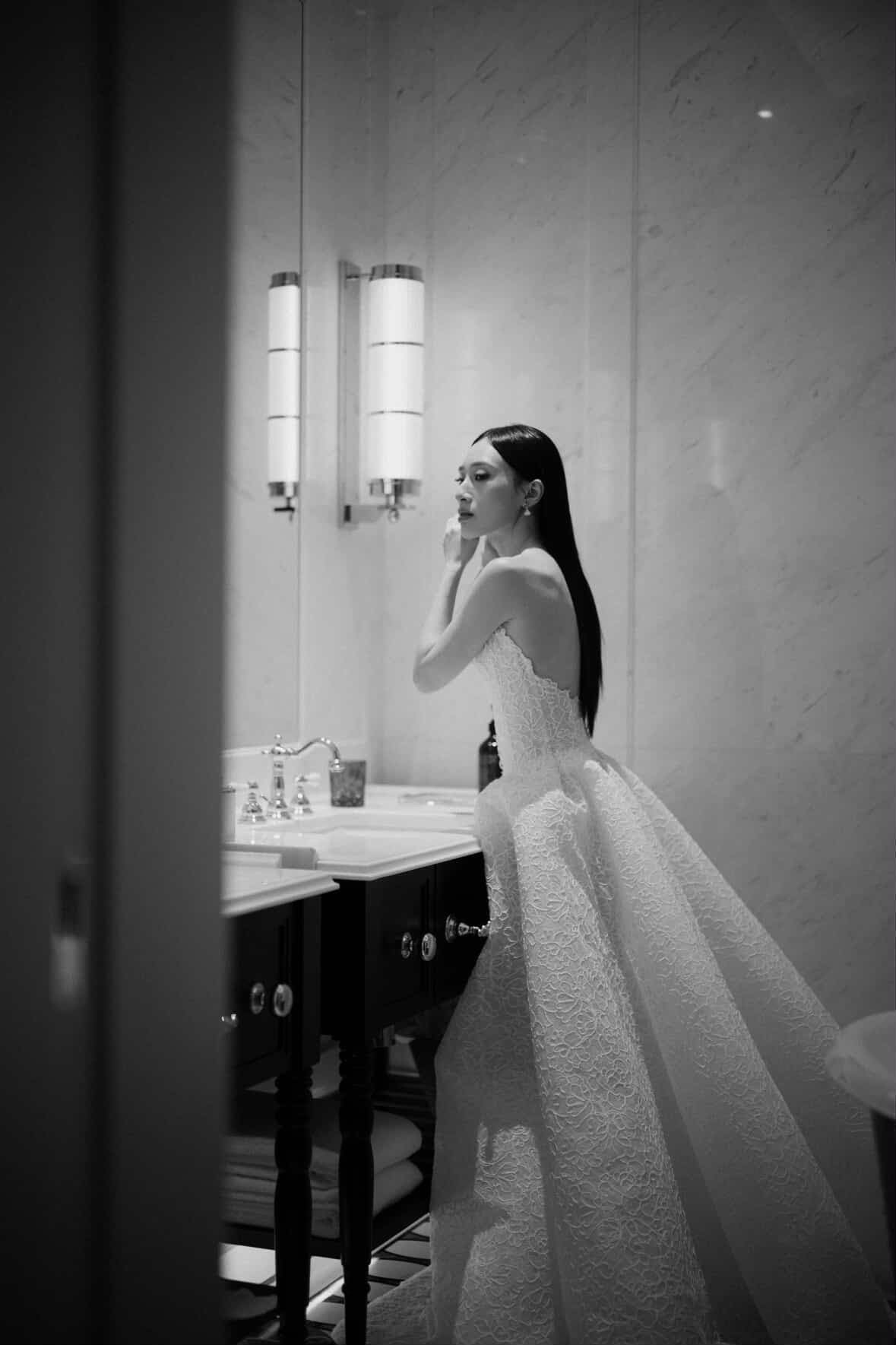 Black-and-white portrait of a bride preparing for her wedding