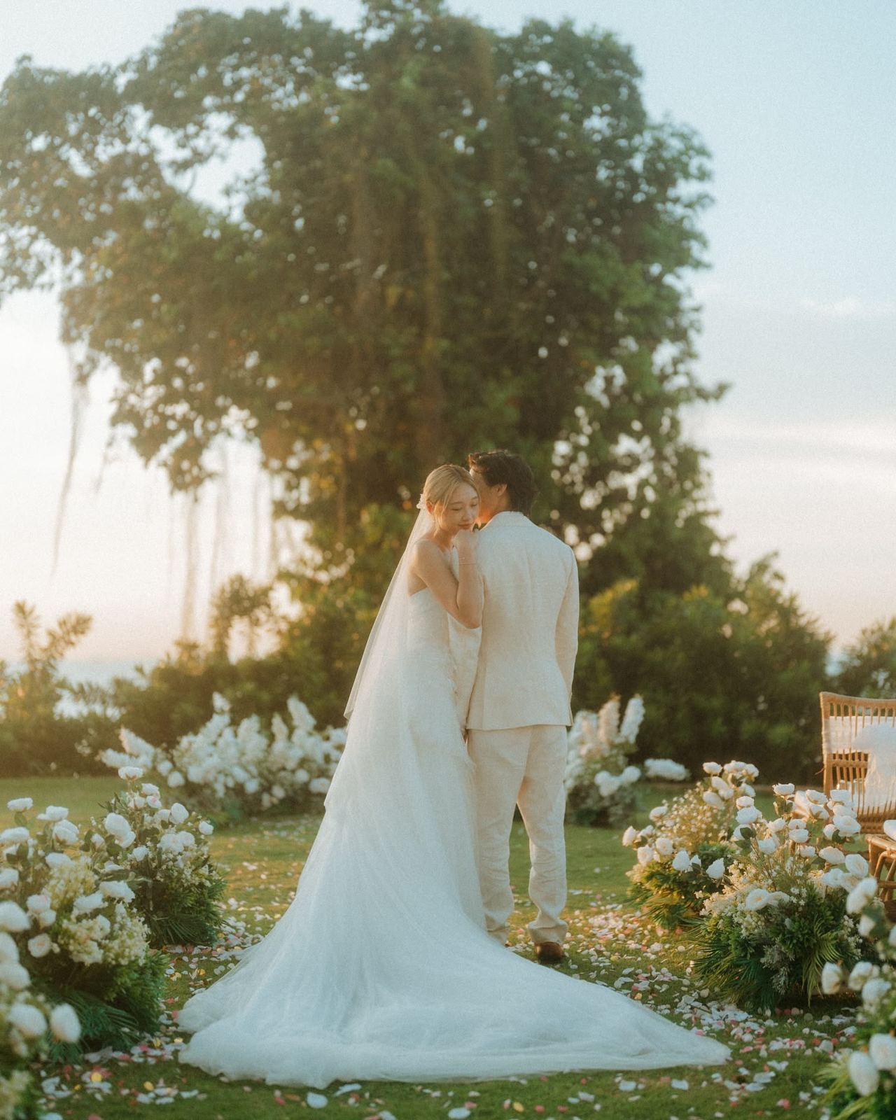 Newlyweds embracing at an outdoor wedding ceremony