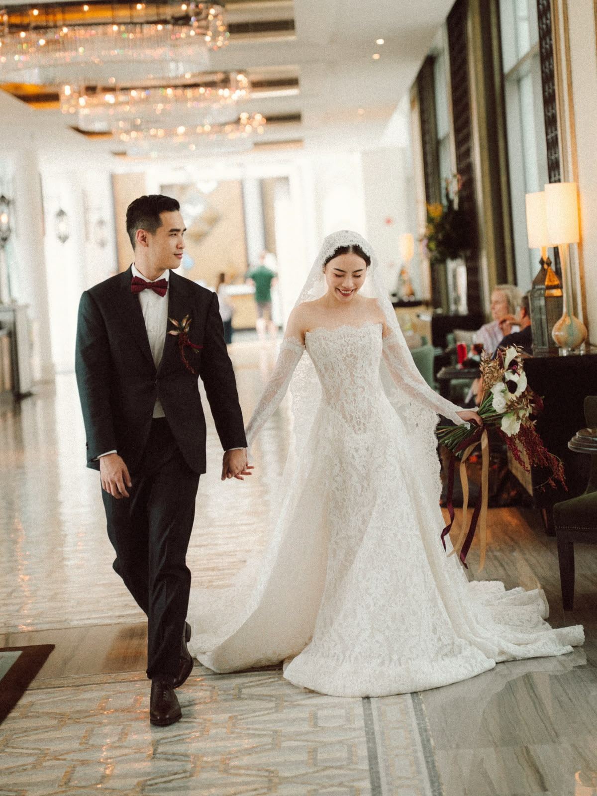 Bride and groom walking together indoors on their wedding day