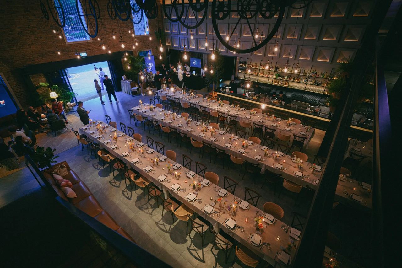 Long tables set for a dinner event in The Warehouse Hotel lobby