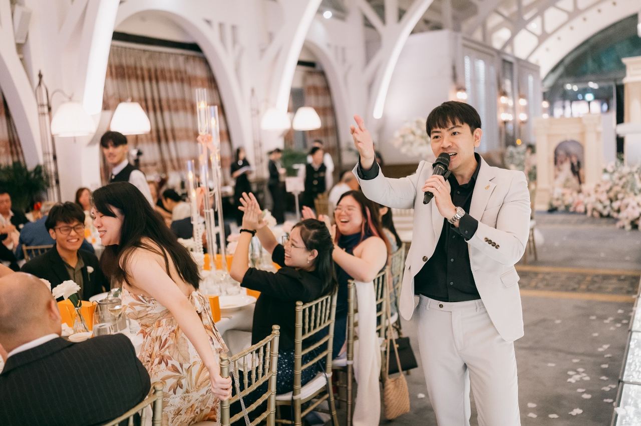 Emcee Rayson energising guests at a wedding banquet