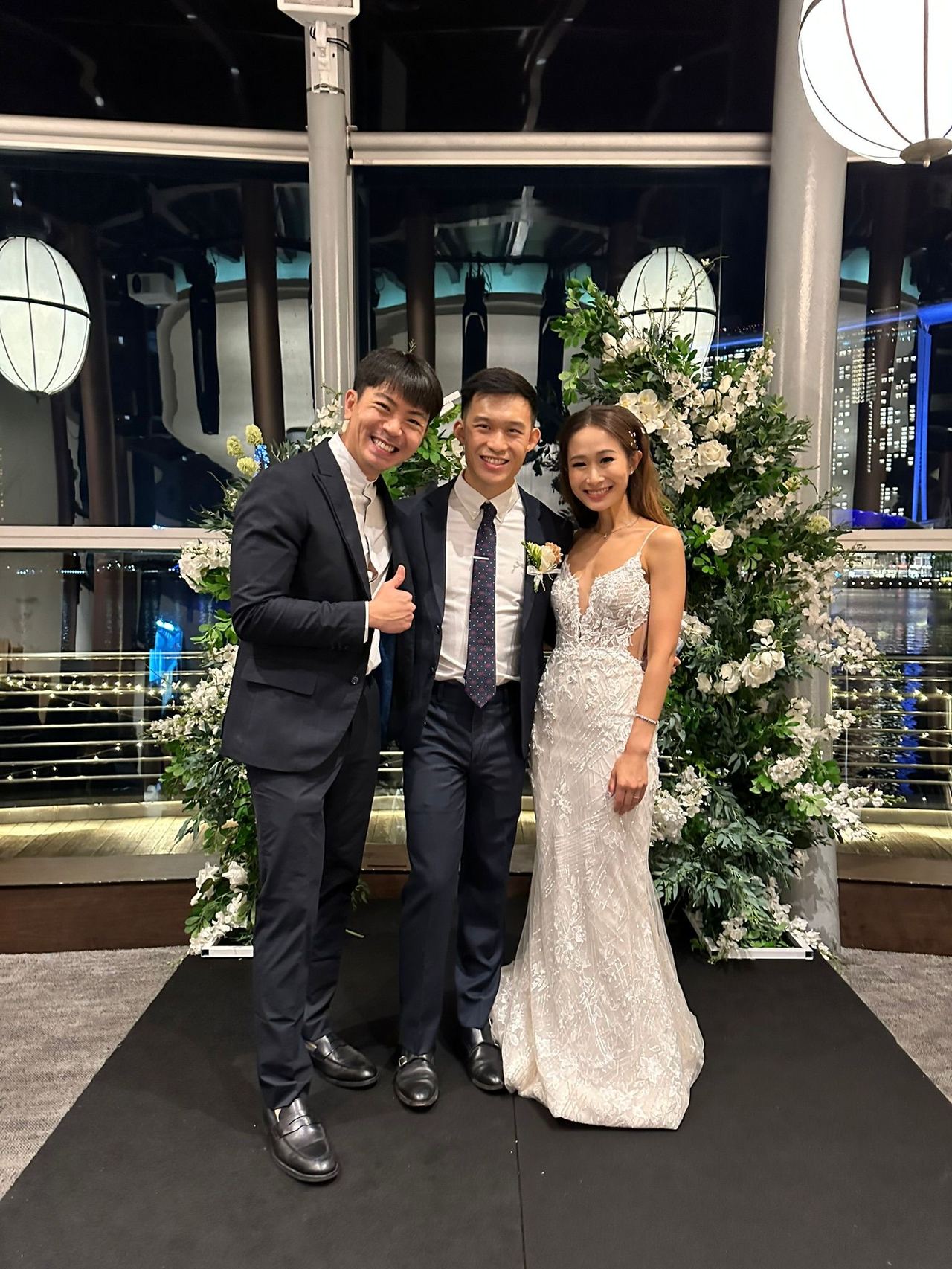 Emcee Rayson with a wedding couple