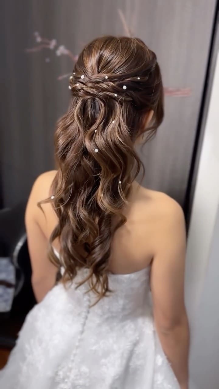 Bridal half-up hairstyle with pearl details by Clara Song Bridal