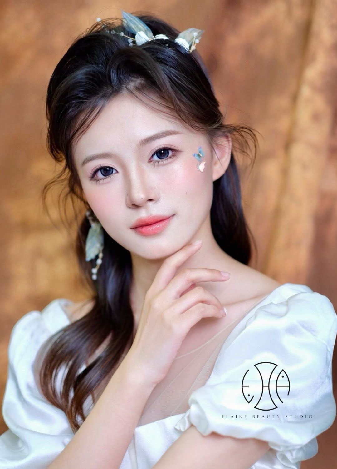 Korean-inspired bridal makeup with luminous skin, soft pink tones and butterfly accents by Elaine Beauty Studio