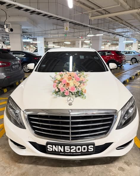 Pearl white Mercedes-Benz S400 bridal car with floral bonnet decoration