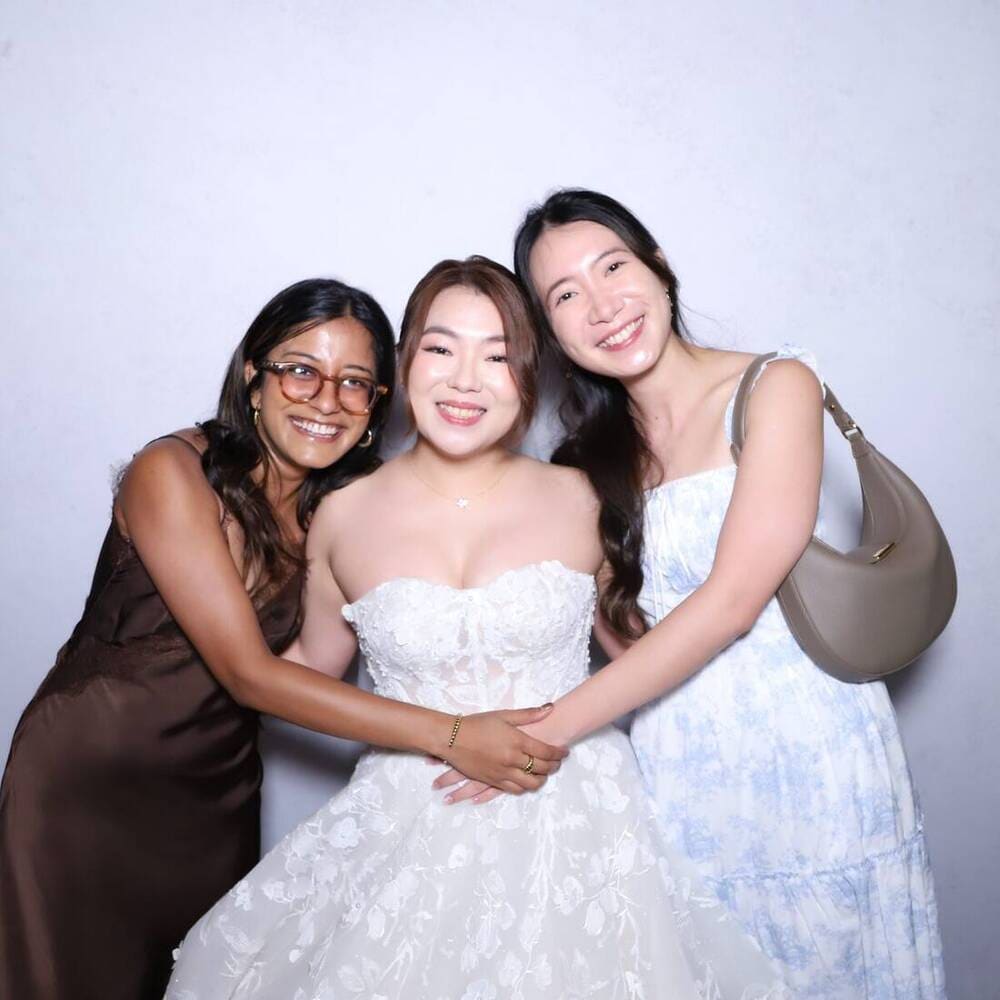 Bride and friends at a Peculiar Booth wedding photobooth