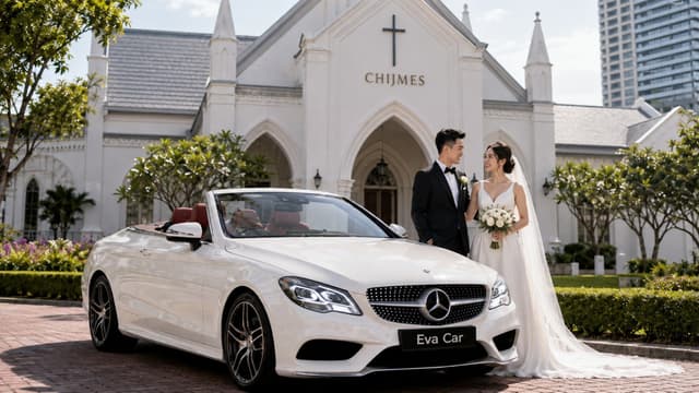 Wedding couple with a white Mercedes cabriolet outside CHIJMES