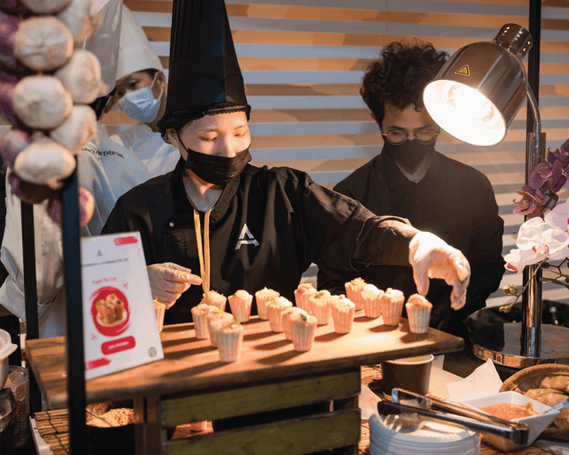 AMICI chef serving at a live station
