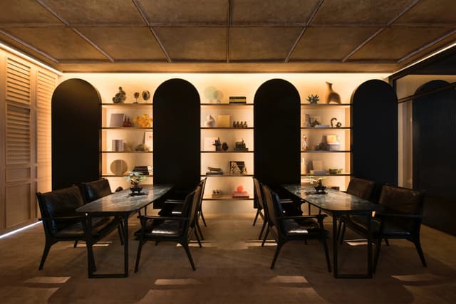 Dining tables and display shelves in The Den at The Warehouse Hotel