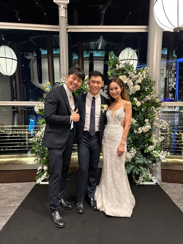 Emcee Rayson with a wedding couple