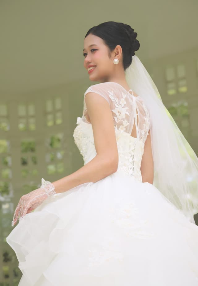 Bride in a white gown posing outdoors