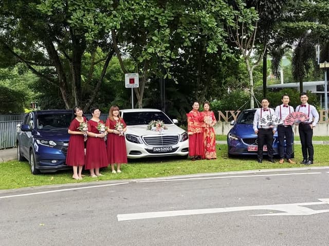 Wedding party posing with decorated bridal cars in Singapore