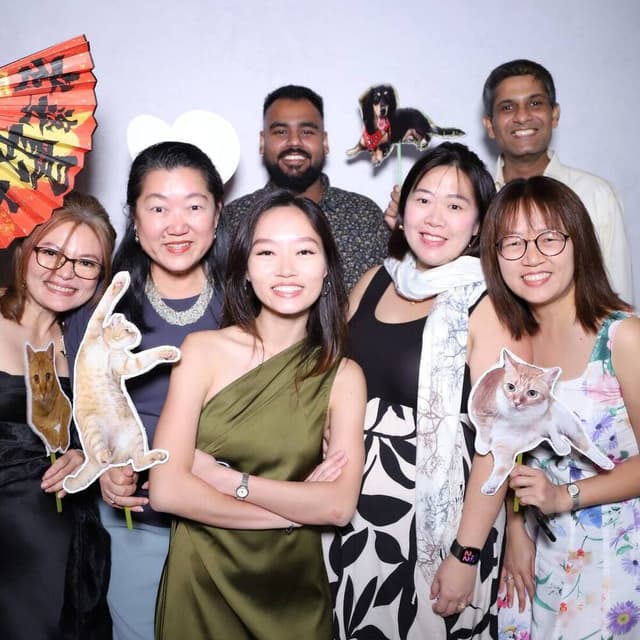 Guests posing with props at a Peculiar Booth event